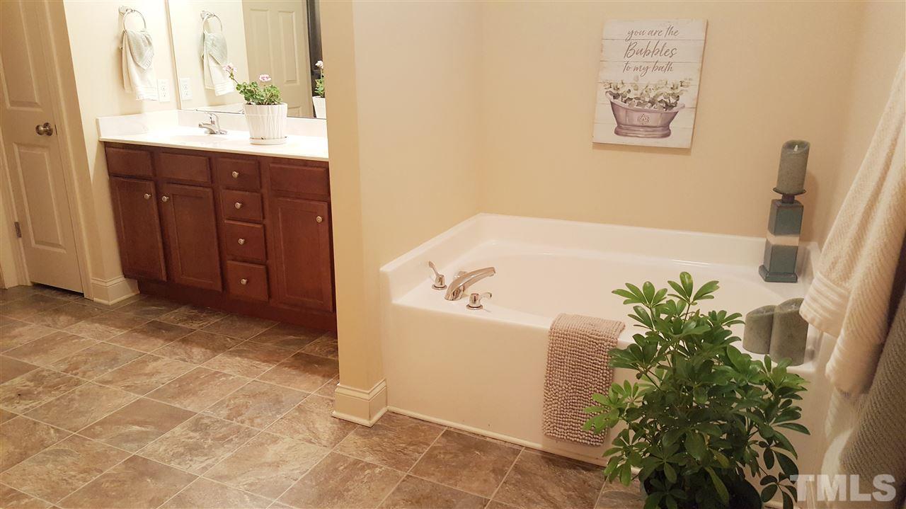 138 Tramway Circle Angier, NC 27501 - Photo 9 of 26 a bathroom with a tub sink and mirror