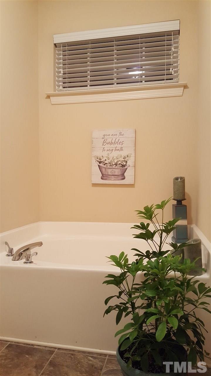 138 Tramway Circle Angier, NC 27501 - Photo 10 of 26 a vase of flowers sitting on a floor