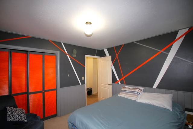 1612 East 450 South Springville, UT 84663 - Photo 25 of 48 Bedroom featuring a decorative accent wall with geometric stripes, louvered bi-fold closet doors, and painted wainscoting