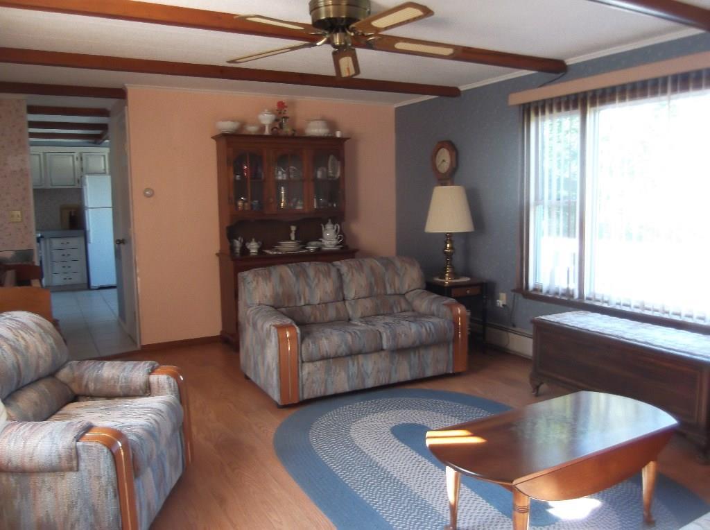 1235 Dexter Road Dover-Foxcroft, ME 04426 - Photo 10 of 26 Living room with laminate floor.