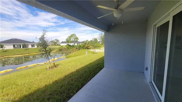a backyard of a house with table and chairs