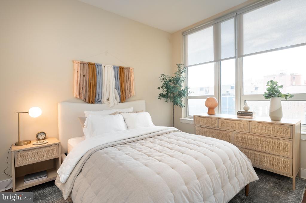 1900-20 Arch Street, Unit 211 Philadelphia, PA 19103 - Photo 5 of 30 a bedroom with a bed and a large window with outer view