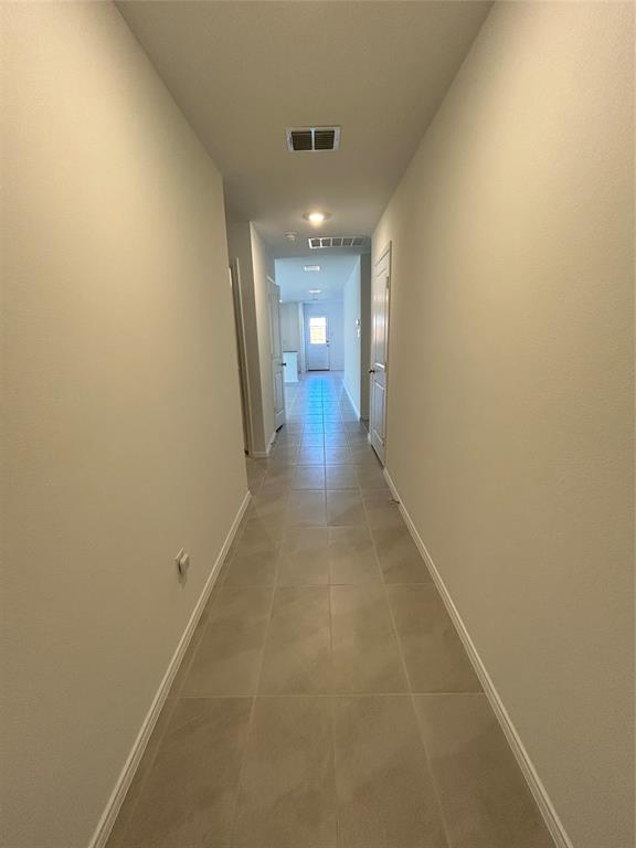 2813 Watchpoint Road Little Elm, TX 75068 - Photo 2 of 8 Corridor with baseboards and light tile patterned floors