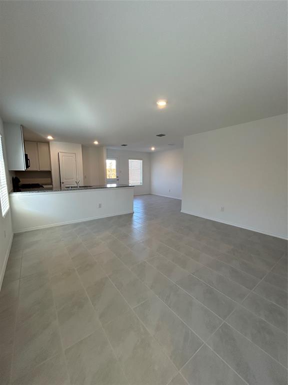 2813 Watchpoint Road Little Elm, TX 75068 - Photo 3 of 8 Unfurnished living room with recessed lighting and light tile patterned flooring