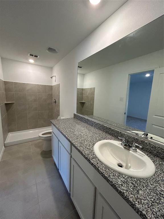 2813 Watchpoint Road Little Elm, TX 75068 - Photo 4 of 8 Bathroom featuring a tile shower and vanity