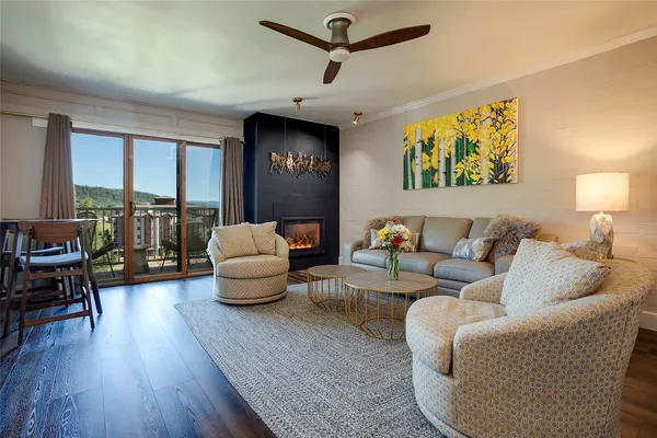 a living room with furniture and a wooden floor