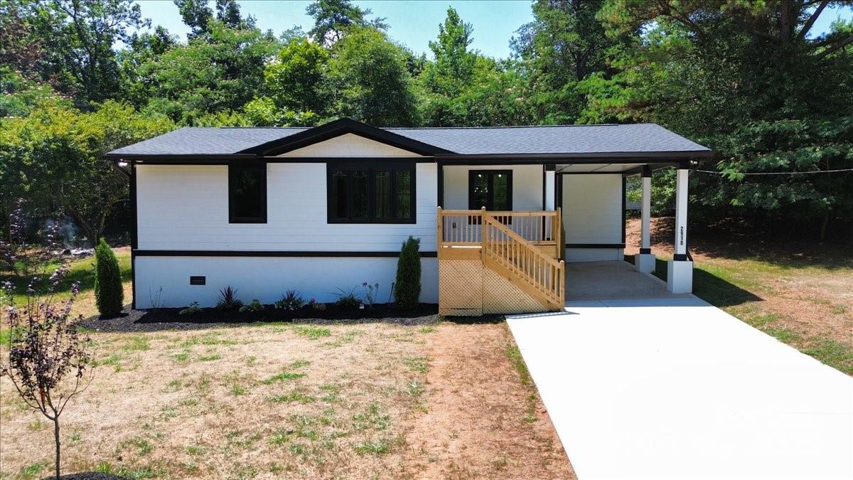 a view of a house with backyard and sitting area