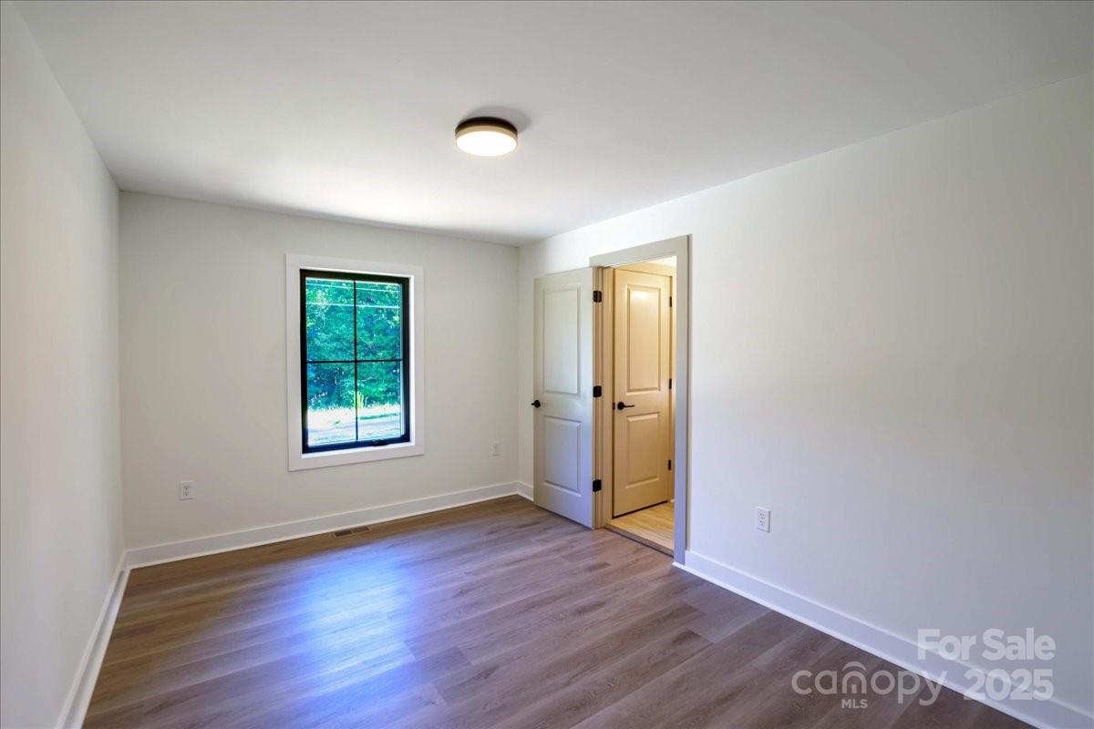 2918 Lon Street Shelby, NC 28152 - Photo 12 of 17 an empty room with wooden floor and windows