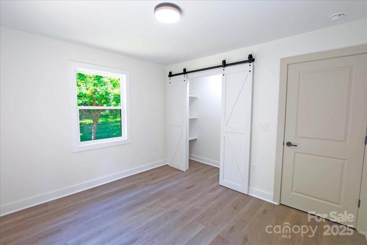 2918 Lon Street Shelby, NC 28152 - Photo 14 of 17 a view of an empty room with wooden floor and a window