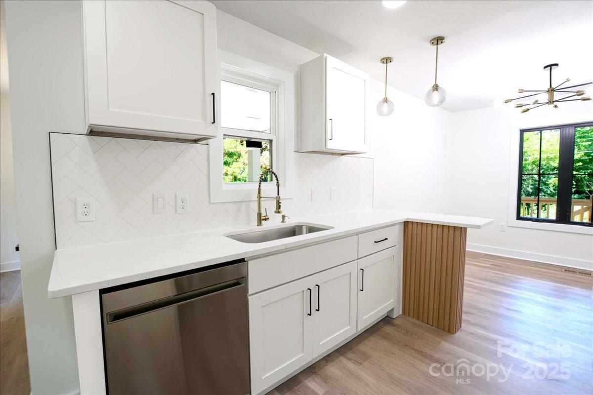 2918 Lon Street Shelby, NC 28152 - Photo 8 of 17 a kitchen with stainless steel appliances white cabinets and wooden floors