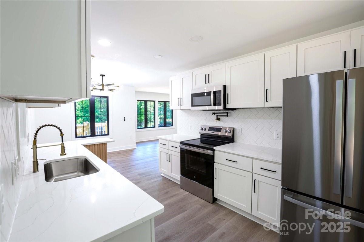 2918 Lon Street Shelby, NC 28152 - Photo 10 of 17 a kitchen with stainless steel appliances granite countertop a refrigerator sink and white cabinets
