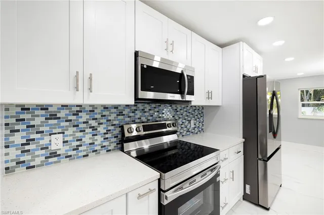 a kitchen with a sink a microwave and refrigerator
