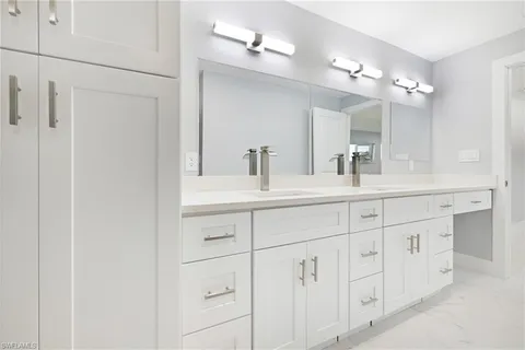 a bathroom with a double vanity sink and a mirror