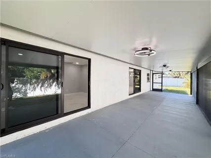 a view of a livingroom with furniture and a kitchen