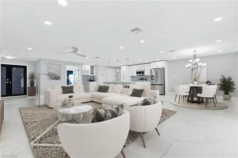 a living room with furniture kitchen view and a table