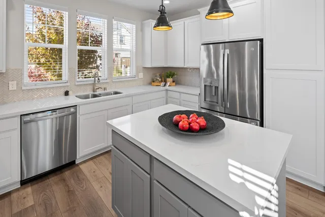 a kitchen with a sink a stove and wooden cabinets