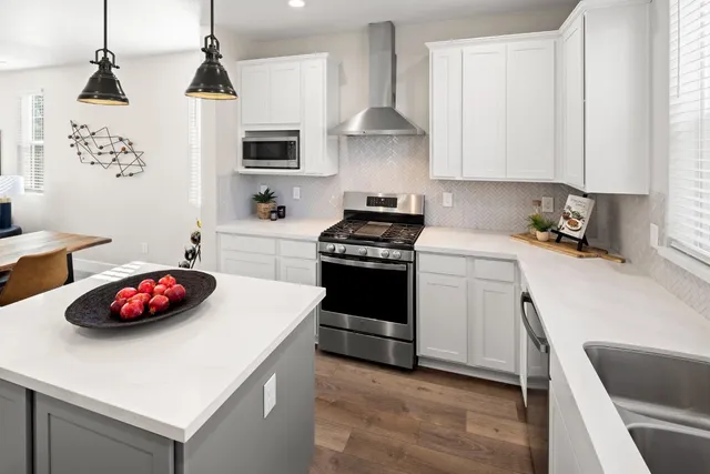 a kitchen with a sink a stove and cabinets