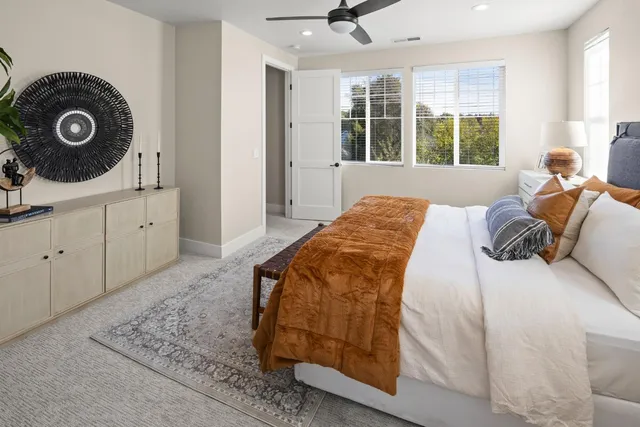 a bedroom with a bed and a window