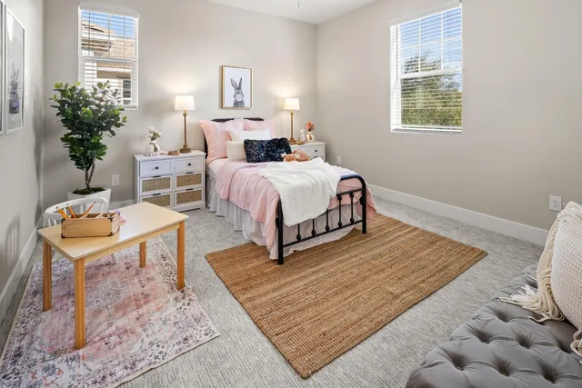 a bedroom with a bed and a table