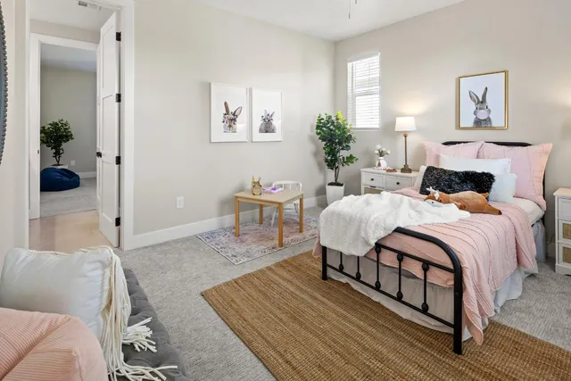 a bedroom with a bed and a table in it