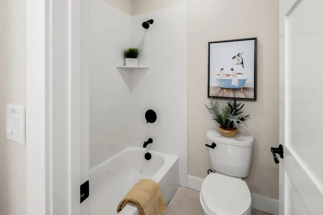 a white toilet sitting next to a bathroom sink