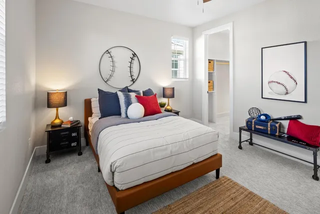 a bedroom with bed and a chandelier