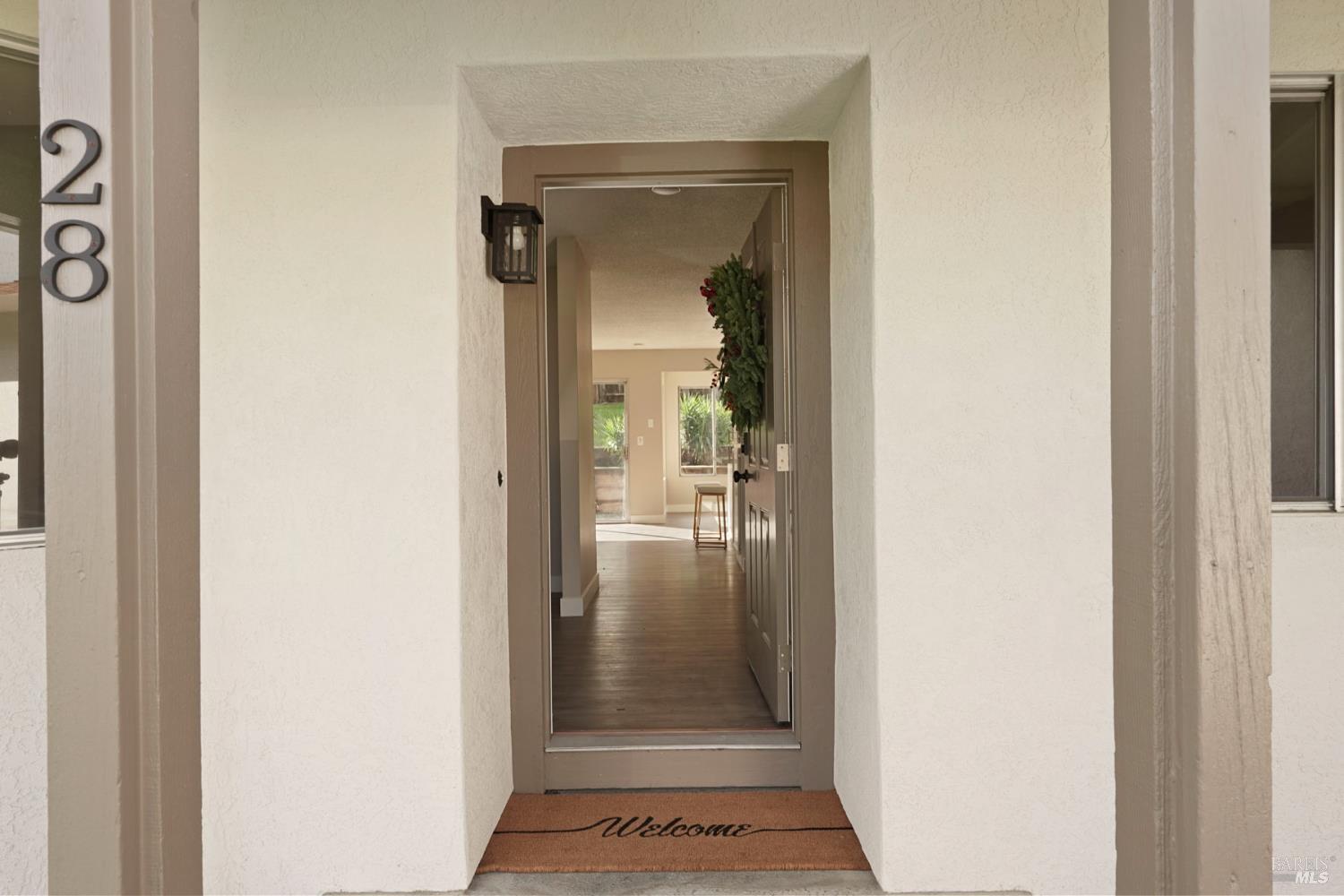 28 Amador Circle Rio Vista, CA 94571 - Photo 14 of 39 a view of a hallway with a glass door and a living room filled with a window