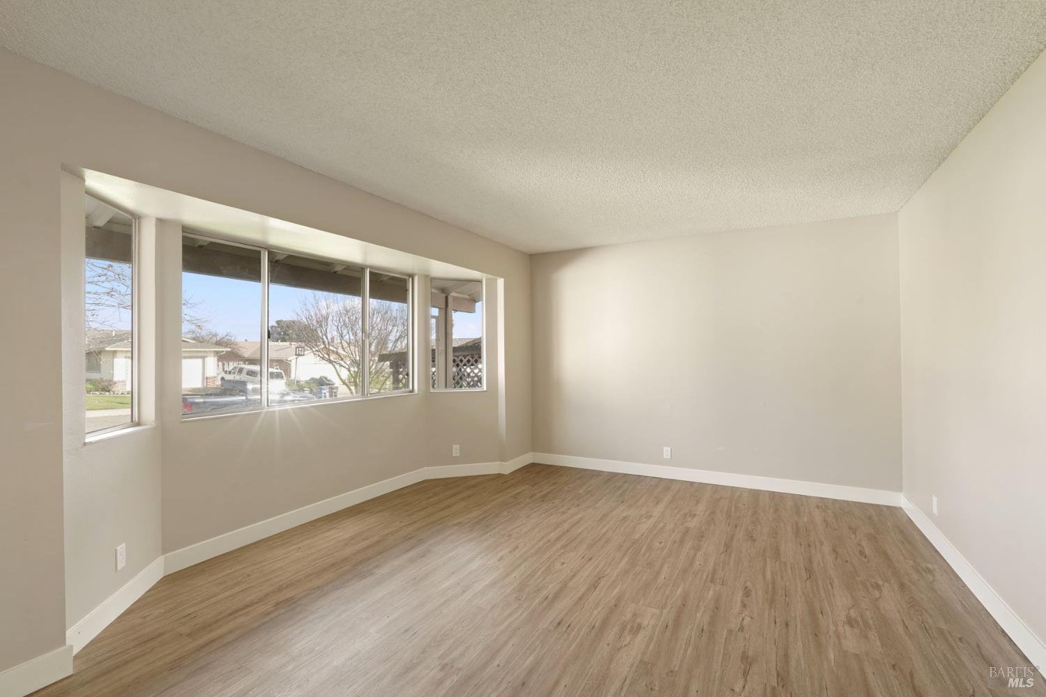 28 Amador Circle Rio Vista, CA 94571 - Photo 15 of 39 an empty room with wooden floor and windows
