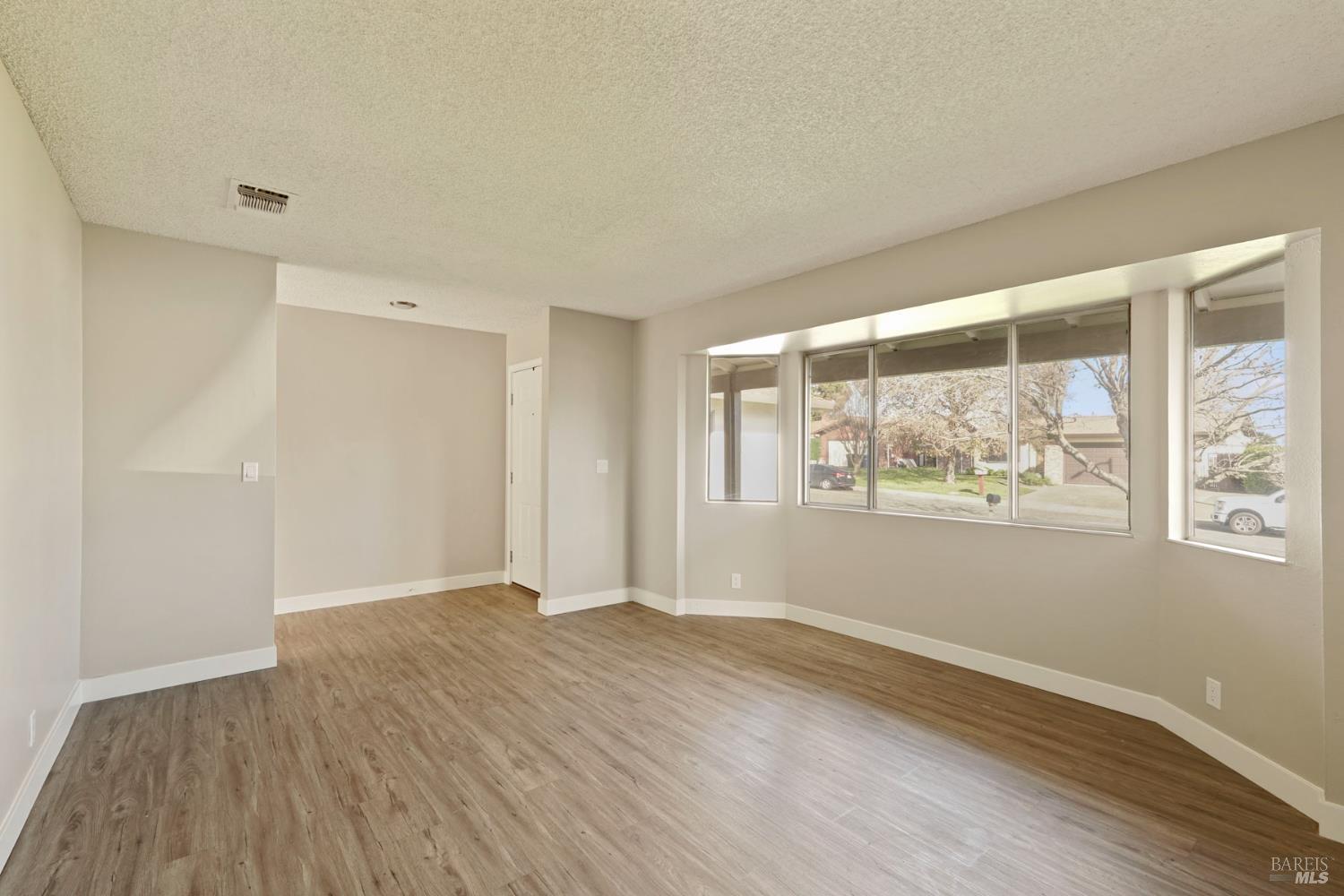 28 Amador Circle Rio Vista, CA 94571 - Photo 16 of 39 an empty room with wooden floor and windows