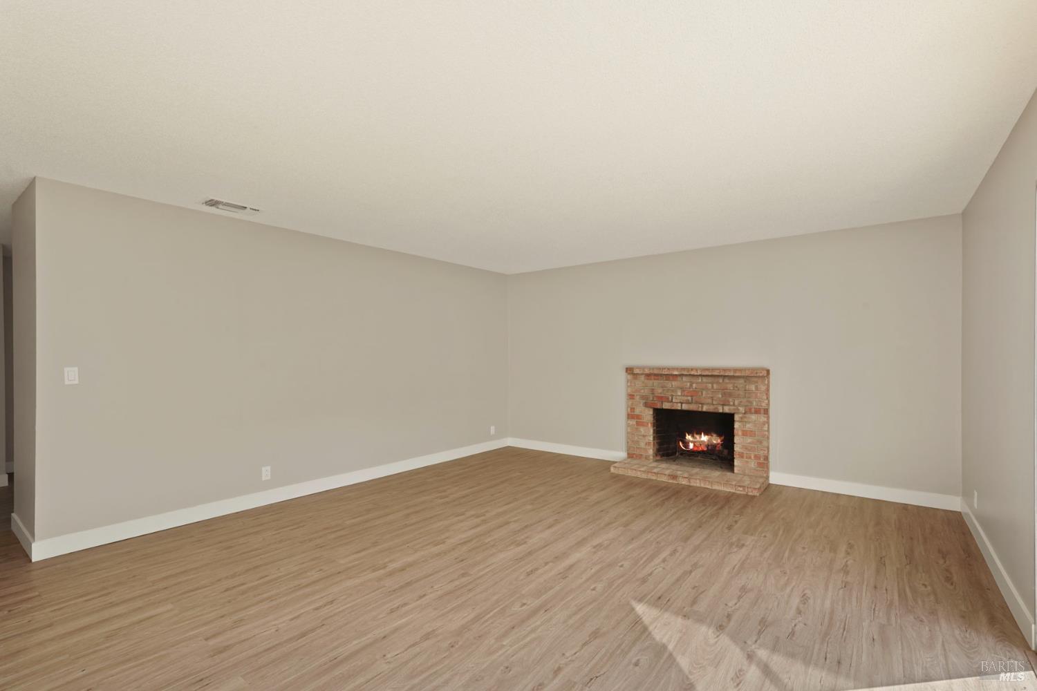 28 Amador Circle Rio Vista, CA 94571 - Photo 17 of 39 a view of an empty room with wooden floor fireplace and a window