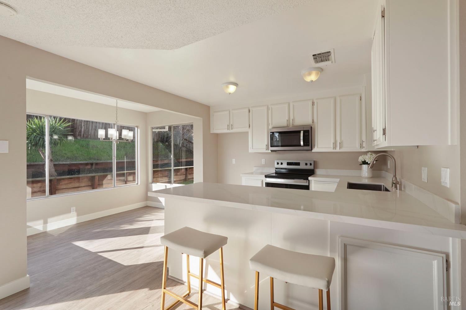 28 Amador Circle Rio Vista, CA 94571 - Photo 21 of 39 a kitchen with stainless steel appliances a stove a sink a microwave a refrigerator and cabinets