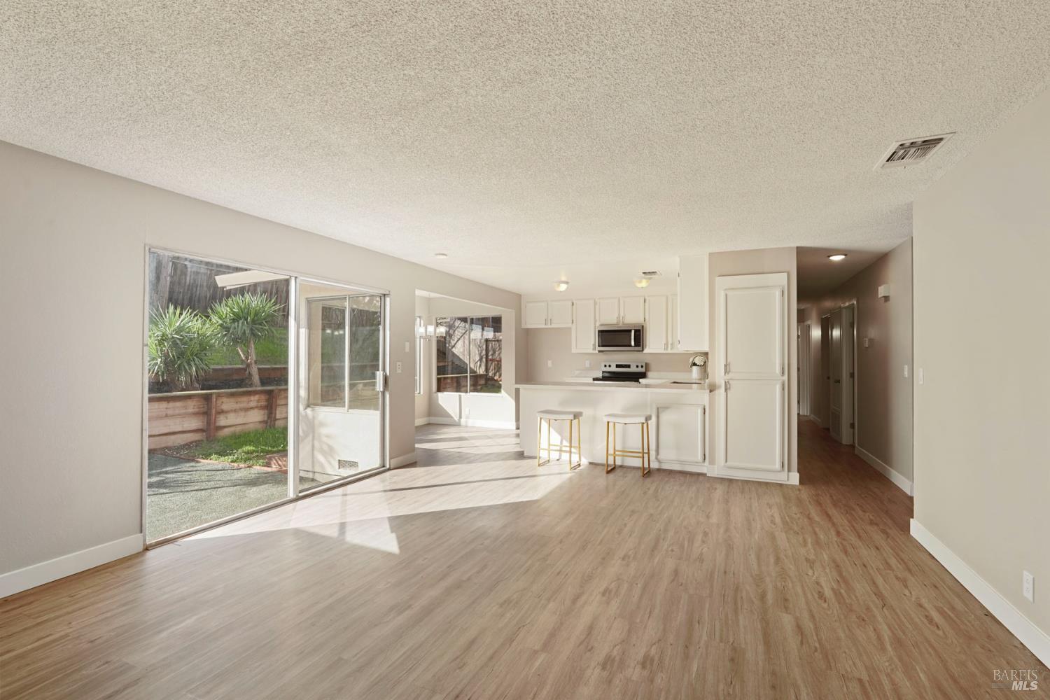 28 Amador Circle Rio Vista, CA 94571 - Photo 22 of 39 a open kitchen with white cabinets and wooden floor