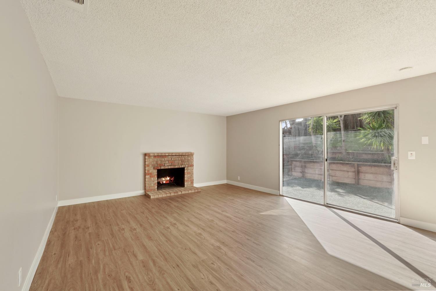 28 Amador Circle Rio Vista, CA 94571 - Photo 3 of 39 a view of an empty room with wooden floor and a window