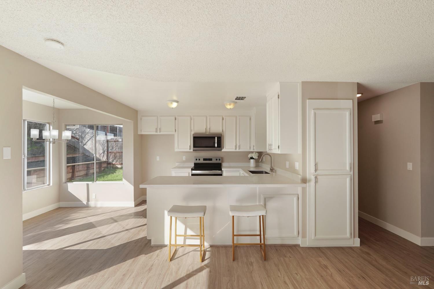 28 Amador Circle Rio Vista, CA 94571 - Photo 5 of 39 a kitchen with white cabinets and refrigerator