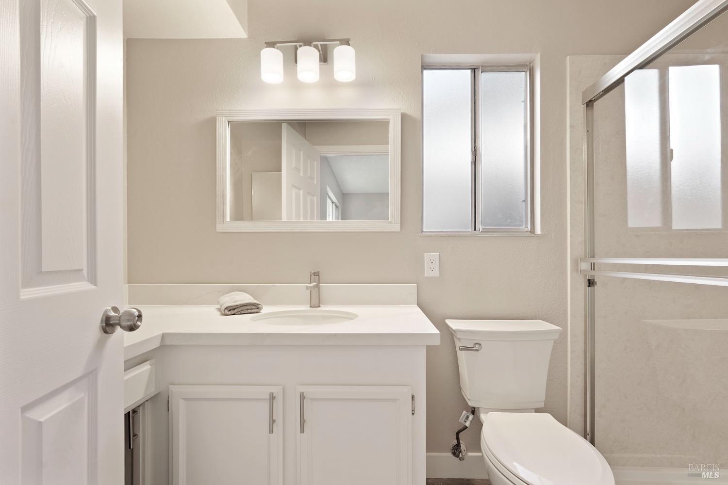 28 Amador Circle Rio Vista, CA 94571 - Photo 8 of 39 a bathroom with a sink a toilet and a mirror