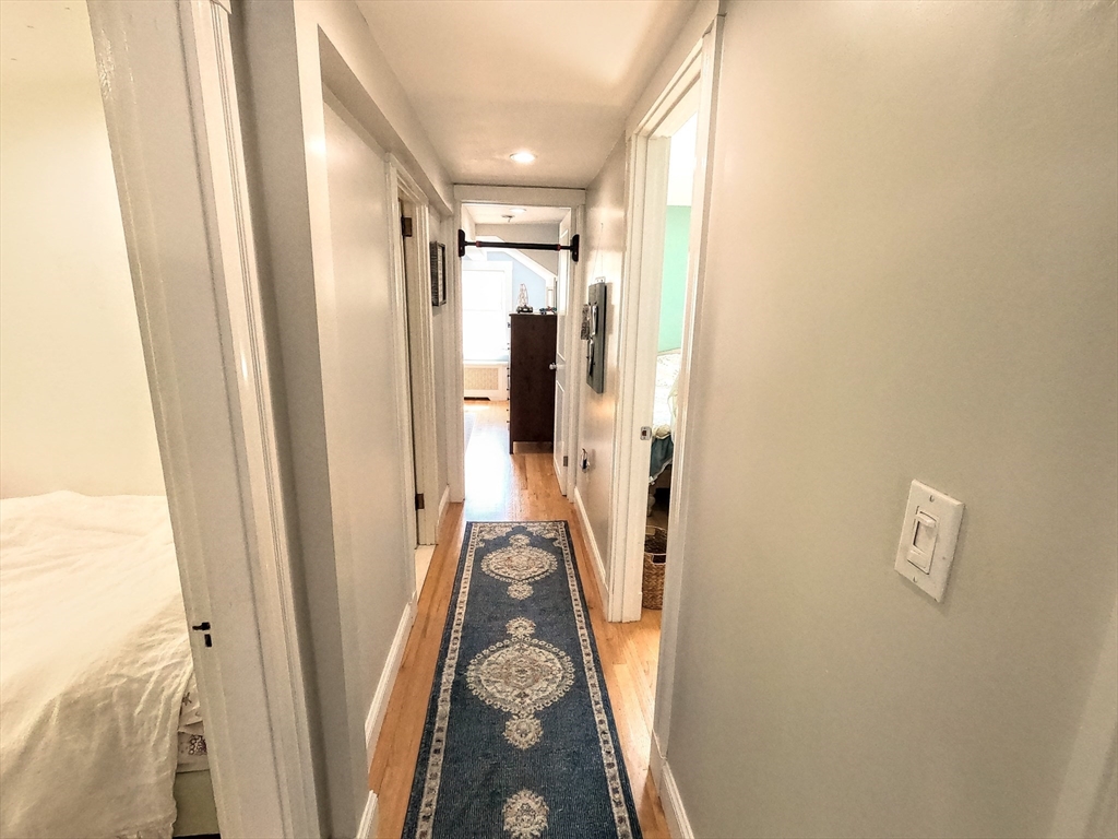 12 Searle Road, Unit 12 Boston, MA 02132 - Photo 25 of 35 a view of a hallway with wooden floor and entryway