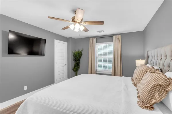 a bedroom with a bed and a window
