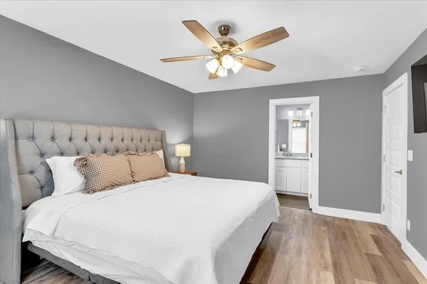 a bedroom with a large bed and a flat screen tv