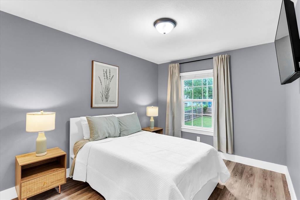 312 East Day Street Denison, TX 75021 - Photo 17 of 24 a bedroom with a bed and a window