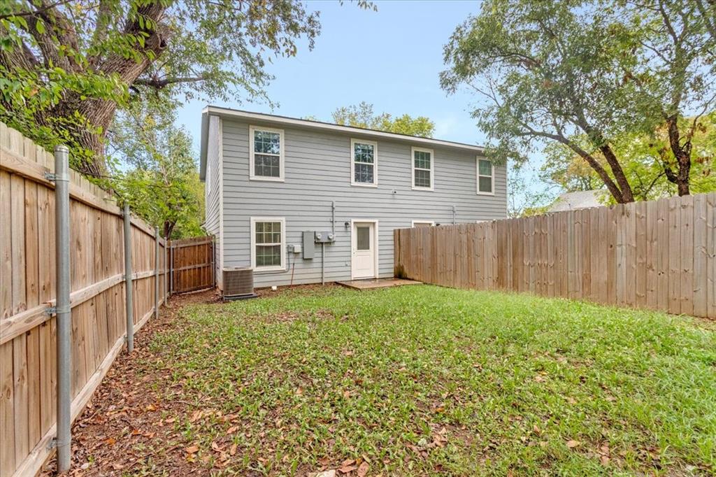 312 East Day Street Denison, TX 75021 - Photo 18 of 24 a view of a backyard with wooden fence and large trees
