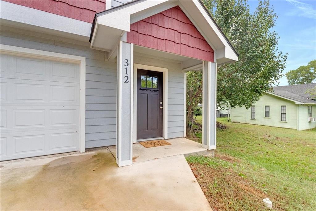 312 East Day Street Denison, TX 75021 - Photo 22 of 24 a view of a house with a yard