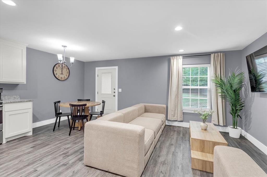 312 East Day Street Denison, TX 75021 - Photo 23 of 24 a living room with furniture wooden floor and a table