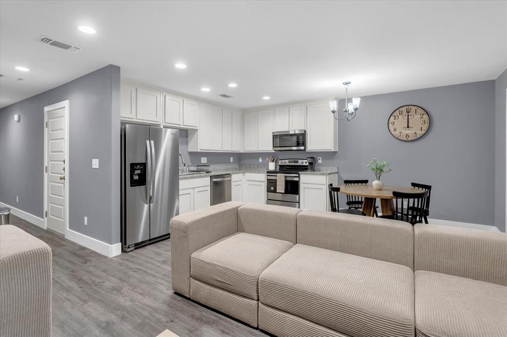 312 East Day Street Denison, TX 75021 - Photo 24 of 24 a living room with stainless steel appliances furniture a refrigerator and a view of kitchen