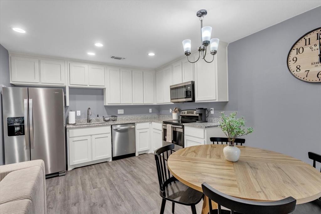 312 East Day Street Denison, TX 75021 - Photo 5 of 24 a kitchen with sink a refrigerator and chairs