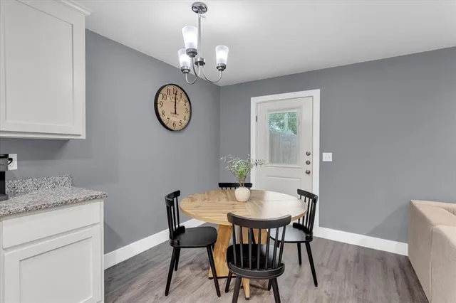 a kitchen with granite countertop white cabinets and stainless steel appliances