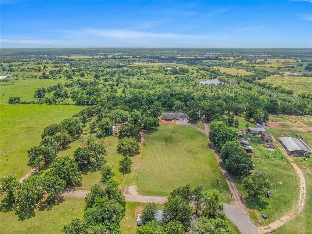 an aerial view of residential houses with outdoor space and swimming pool