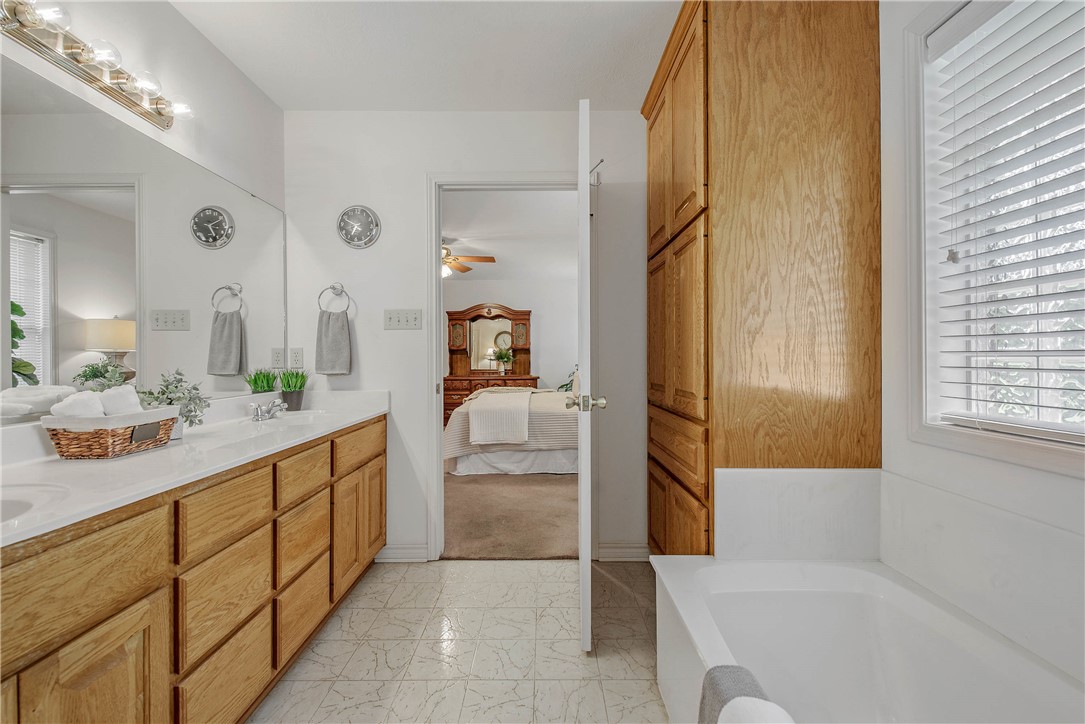 1110 County Road 439 Dime Box, TX 77853 - Photo 28 of 50 a bathroom with a tub sink and mirror