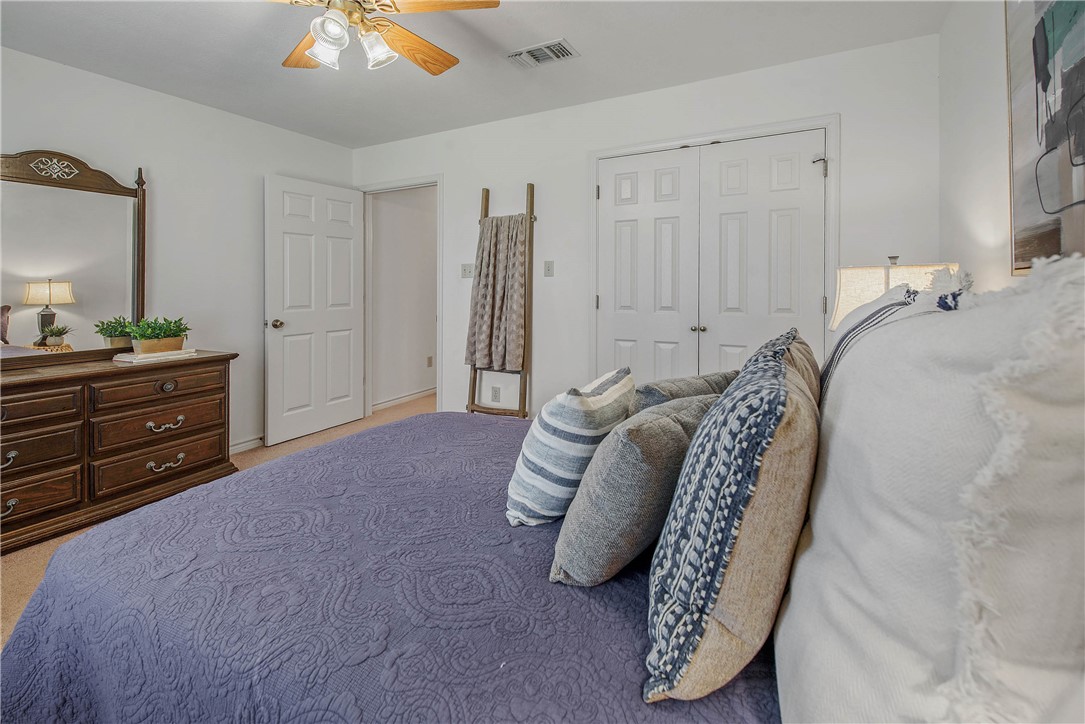 1110 County Road 439 Dime Box, TX 77853 - Photo 31 of 50 a bedroom with a bed and a chandelier