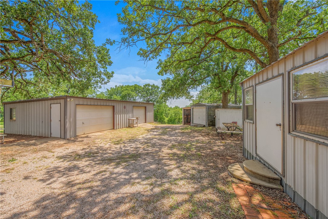 1110 County Road 439 Dime Box, TX 77853 - Photo 44 of 50 a view of a backyard with large trees and wooden fence