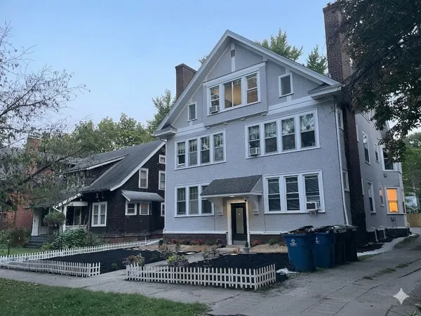 a front view of a house with a garden